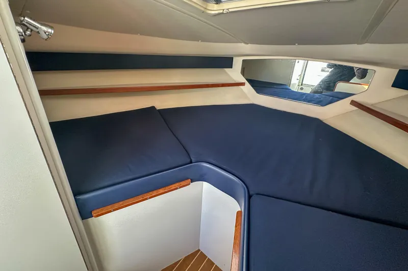 Slide: The Image of Interior cabin of 2001 Tiara Yachts 2900 Coronet with blue cushions and wood accents. - 21