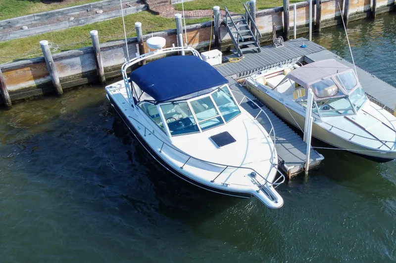 Slide: The Image of 2001 Tiara Yachts 2900 Coronet docked beside another boat at a marina. - 38
