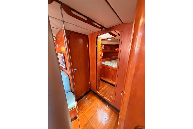 Slide: The Image of Interior of 1991 Hylas 51 yacht, featuring polished wood and cozy cabin space. - 97