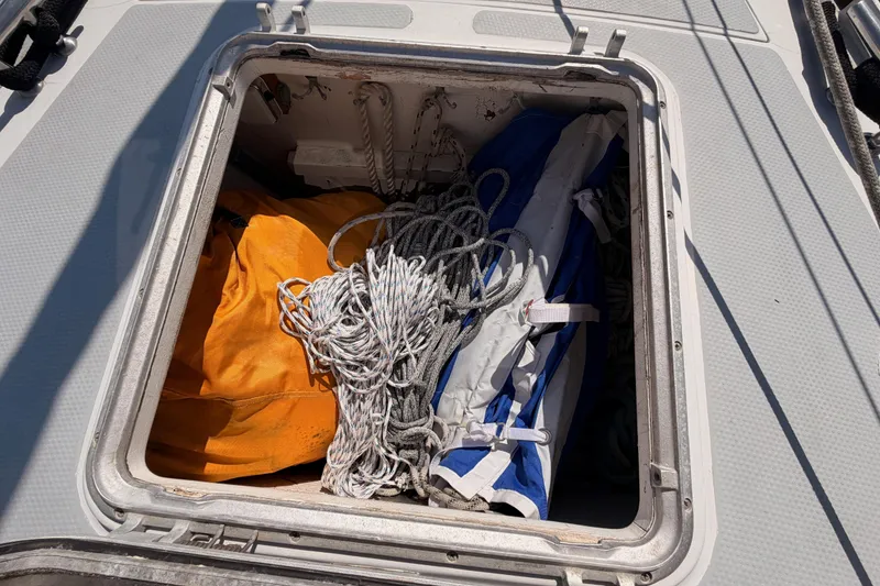 Slide: The Image of Open hatch on 1991 Hylas 51 sailboat, showing ropes and gear storage. - 14