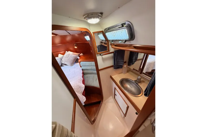 Slide: The Image of Cozy cabin interior of a 1991 Hylas 51 yacht with bed and sink area. - 69