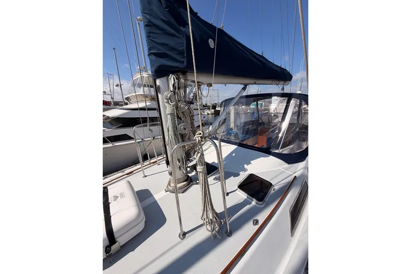 Slide: The Image of Sailboat deck of 1991 Hylas 51 with rigging and canopy in marina. - 26