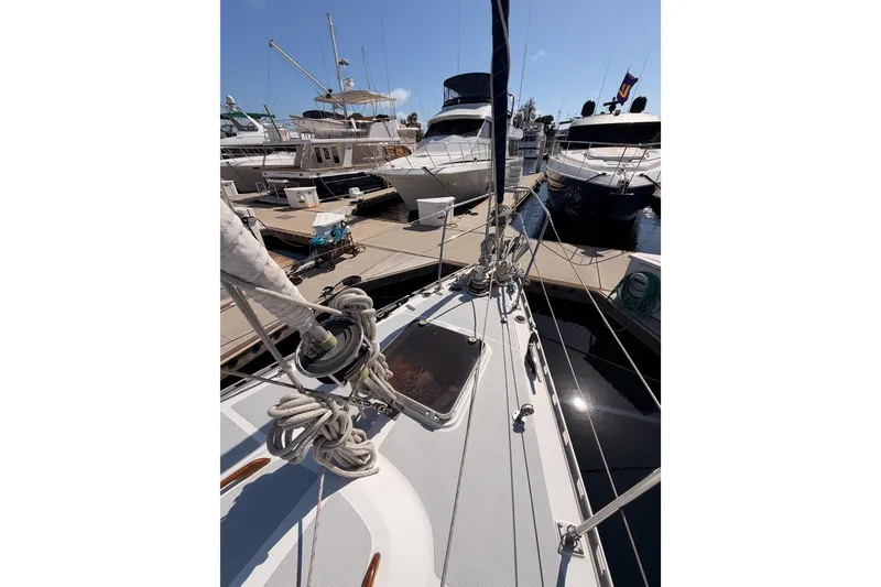 Slide: The Image of Sailboat Hylas 51, 1991 model, docked at marina with other yachts. - 13