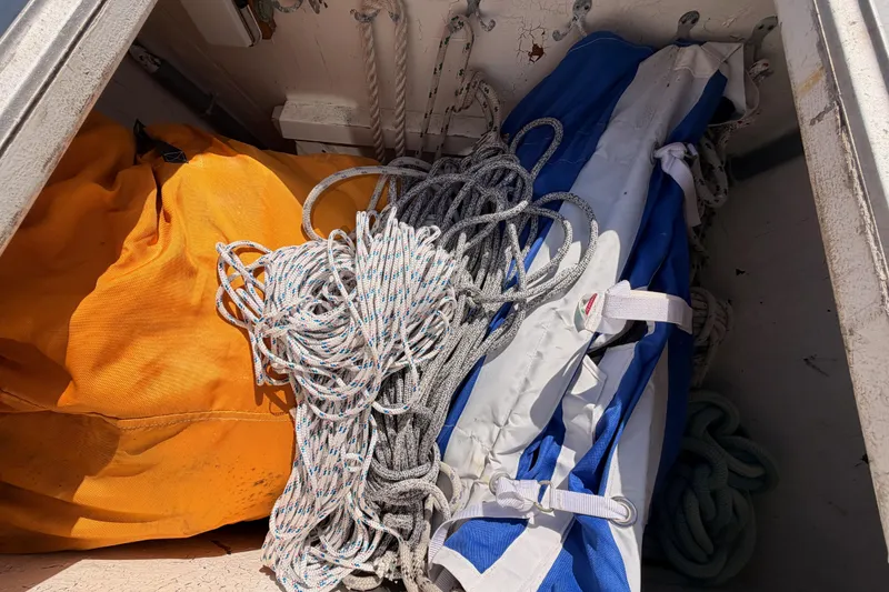 Slide: The Image of Storage compartment of a 1991 Hylas 51 sailboat with ropes and sails. - 15