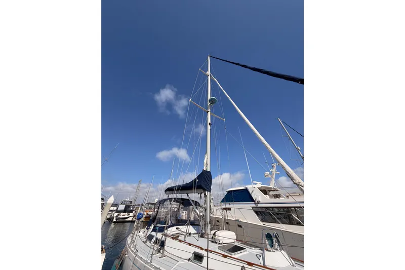 Slide: The Image of Sailboat Hylas 51 from 1991 docked under a clear blue sky. - 4