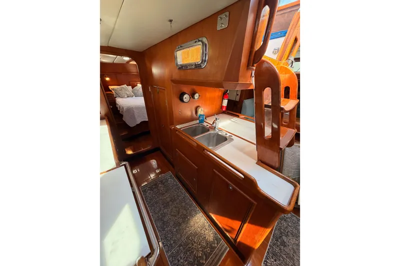 Slide: The Image of Interior of 1991 Hylas 51 yacht featuring a cozy kitchen and sleeping area. - 85