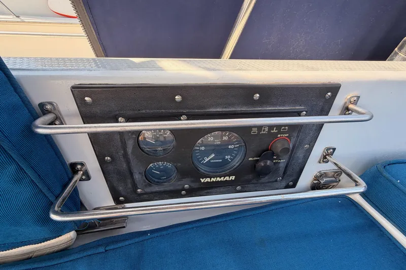 Slide: The Image of Control panel of a 1991 Hylas 51 yacht featuring Yanmar engine gauges. - 46