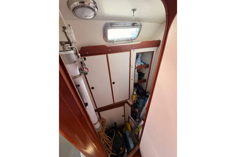 Slide: The Image of Interior storage area of a 1991 Hylas 51 yacht with shelves and equipment. - 98