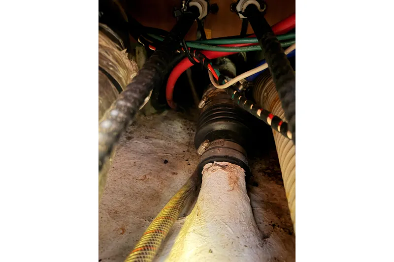 Slide: The Image of Wiring and hoses inside a 1991 Hylas 51 yacht, showcasing complex marine engineering. - 91