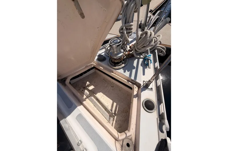 Slide: The Image of Open hatch on 1991 Hylas 51 sailboat deck with coiled ropes and winch. - 17