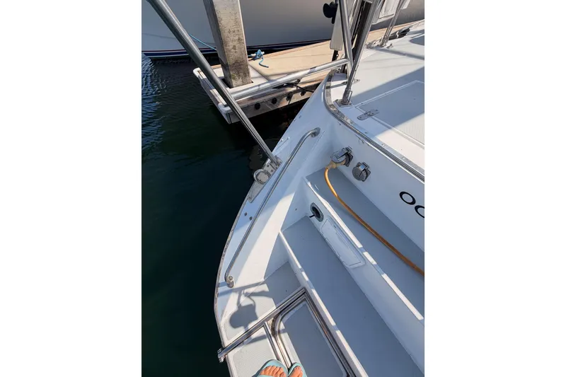 Slide: The Image of Stern view of a 1991 Hylas 51 yacht docked at a marina. - 34