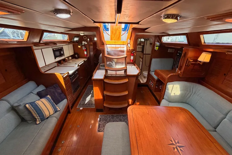 Slide: The Image of Luxurious interior of a 1991 Hylas 51 yacht with elegant wood finishes and cozy seating. - 110