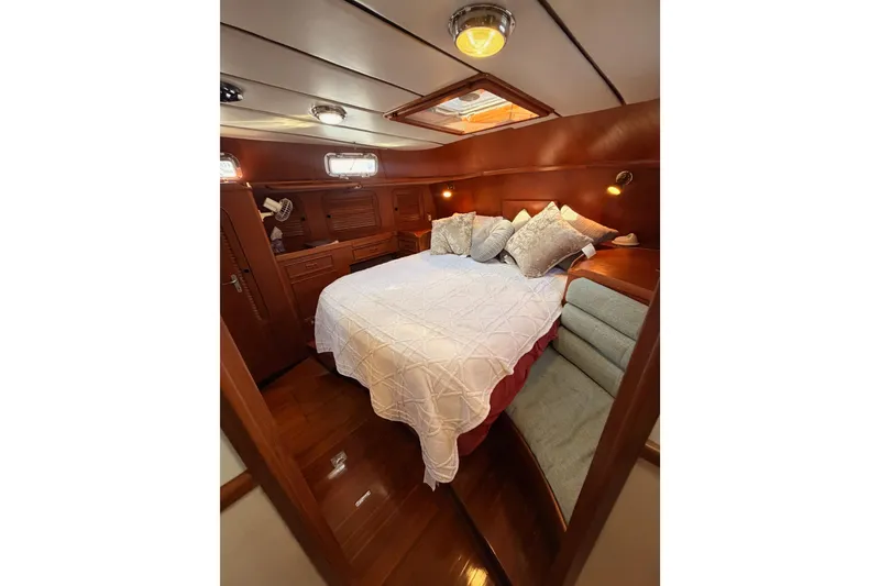 Slide: The Image of Luxurious cabin interior of a 1991 Hylas 51 yacht with cozy bedding and wood finish. - 71