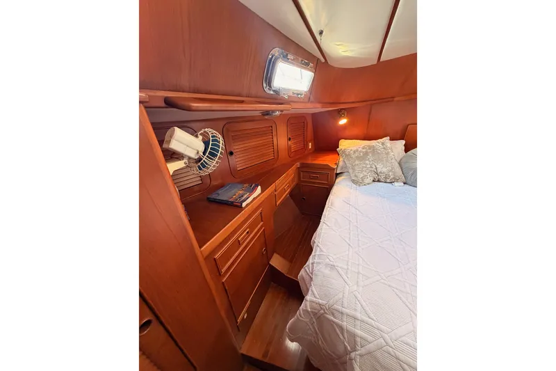 Slide: The Image of Cozy cabin interior of 1991 Hylas 51 yacht with wooden furnishings and bed. - 76