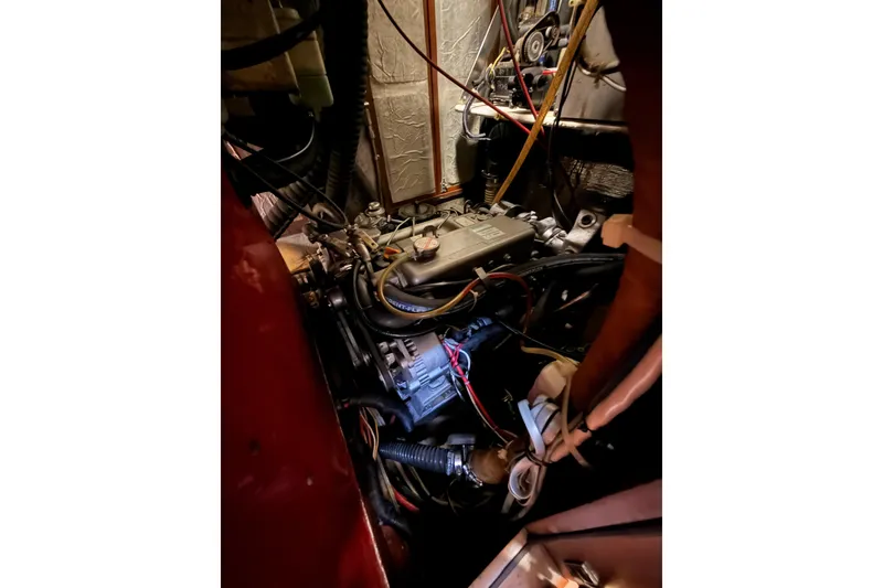 Slide: The Image of Engine compartment of a 1991 Hylas 51 sailboat, showcasing wiring and mechanical components. - 65