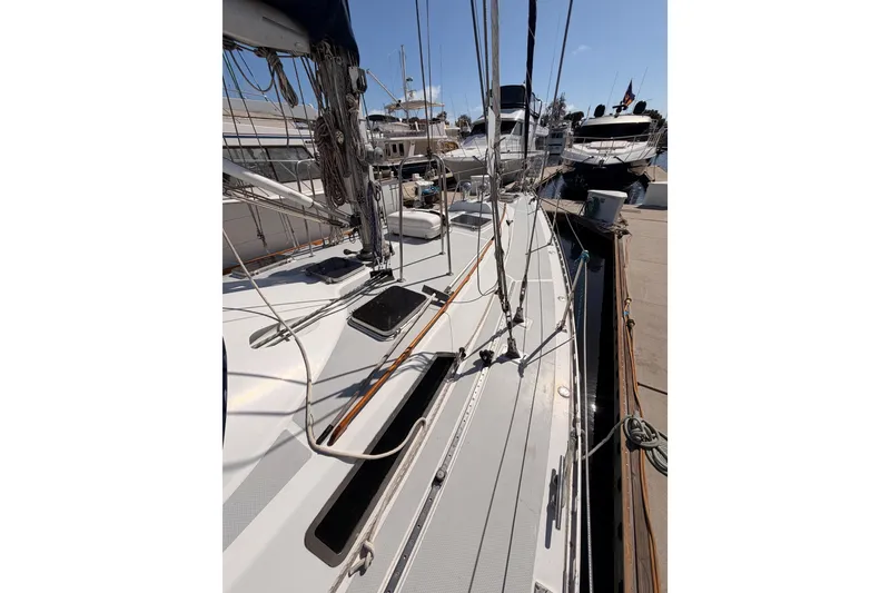 Slide: The Image of Sailboat docked at marina, Hylas 51 model, 1991, with visible rigging and deck details. - 11