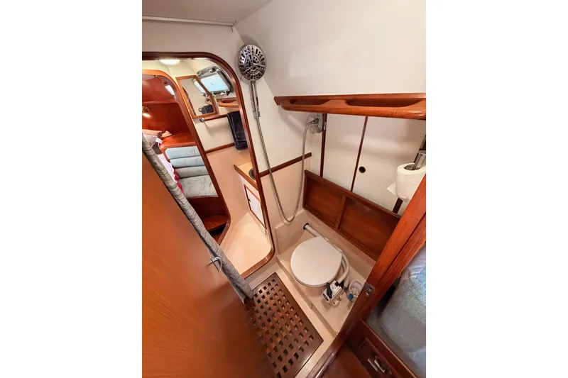 Slide: The Image of Bathroom interior of a 1991 Hylas 51 yacht, featuring wooden accents and compact design. - 68