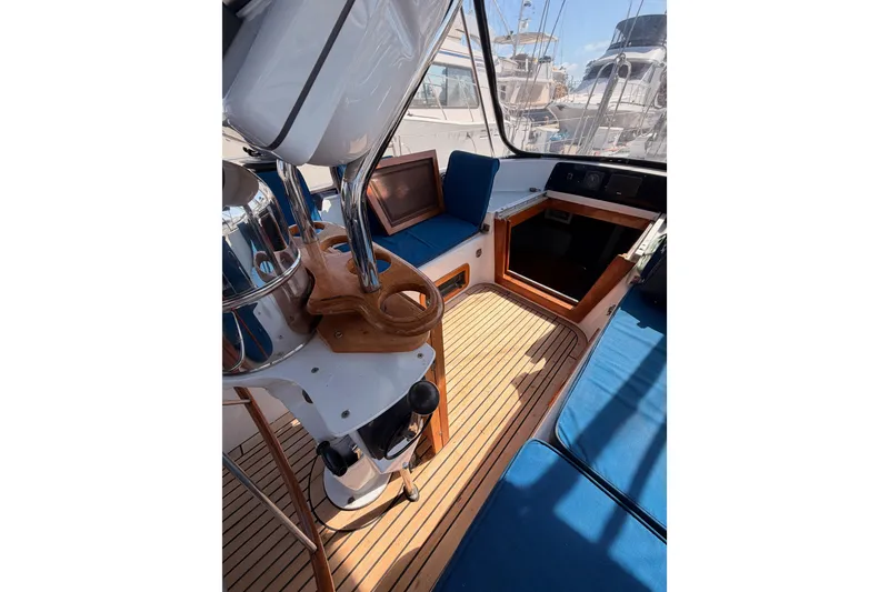 Slide: The Image of Interior view of a 1991 Hylas 51 yacht cockpit with wooden flooring and blue seating. - 45