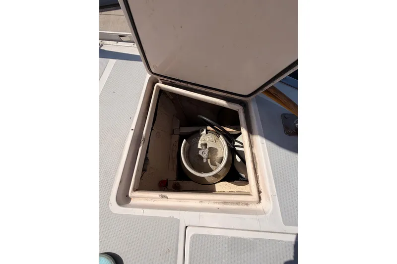 Slide: The Image of Open hatch on 1991 Hylas 51 sailboat deck, revealing storage compartment. - 32
