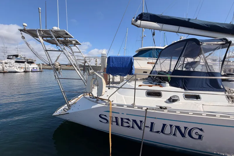Slide: The Image of Sailboat "Shen-Lung" docked, Hylas 51 model, 1991, in a marina with clear skies. - 7