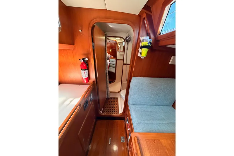 Slide: The Image of Interior of 1991 Hylas 51 yacht with wooden finish and cozy seating area. - 64