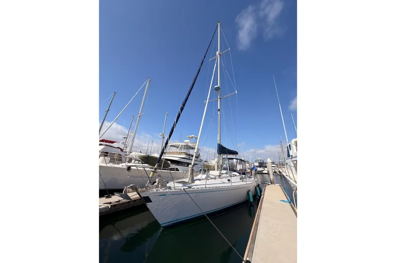 Slide: The Image of Sailboat docked at marina, Hylas 51 model, 1991, under clear blue sky. - 2