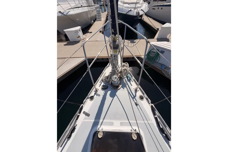 Slide: The Image of Bow view of a 1991 Hylas 51 yacht docked at a marina. - 16