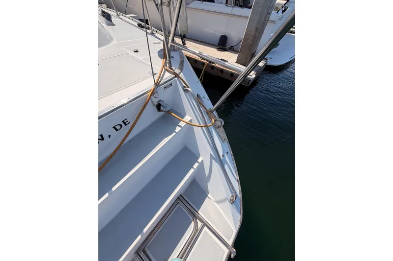 Slide: The Image of Stern view of a 1991 Hylas 51 yacht docked at a marina. - 35