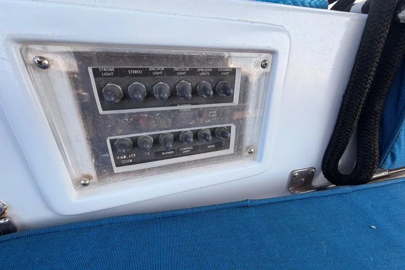 Slide: The Image of Control panel on a 1991 Hylas 51 yacht with various switches and blue seating. - 47
