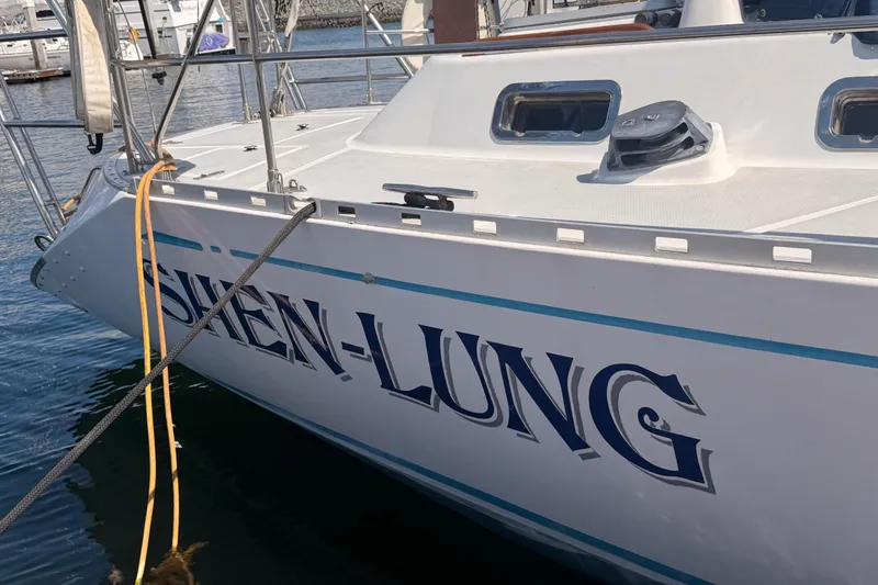 Slide: The Image of Sailboat "SHEN-LUNG" docked, Hylas 51 model, 1991, in a marina setting. - 8
