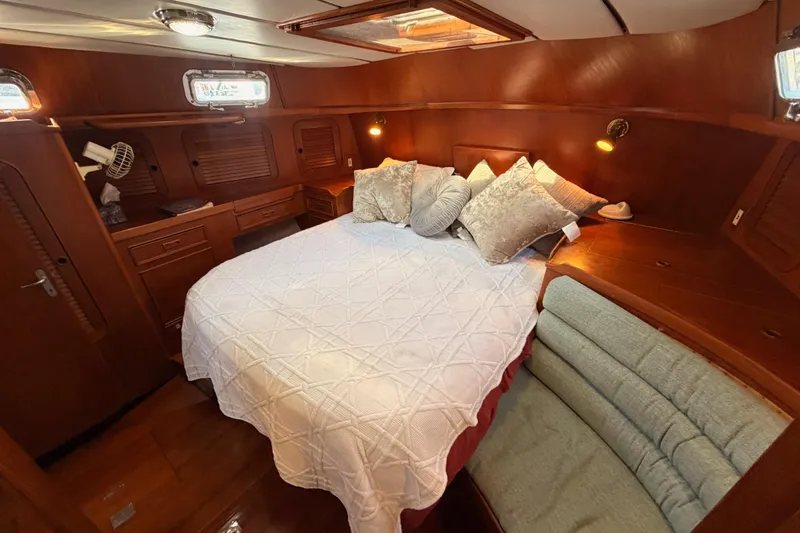 Slide: The Image of Luxurious cabin interior of a 1991 Hylas 51 yacht with cozy bedding and wooden furnishings. - 72