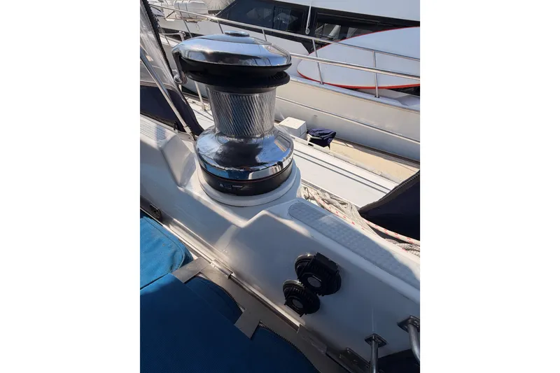 Slide: The Image of Winch on 1991 Hylas 51 sailboat deck, with ropes and railing visible. - 44