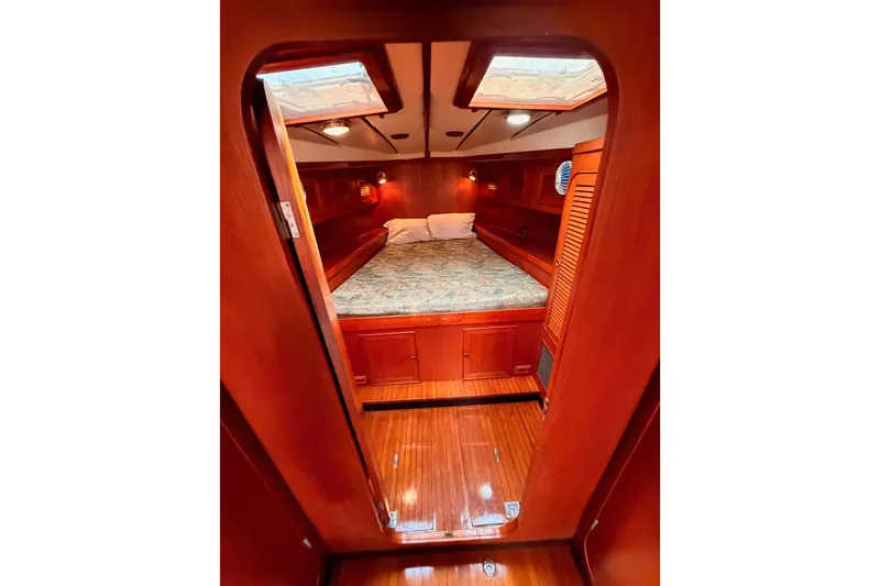 Slide: The Image of Cozy cabin interior of a 1991 Hylas 51 yacht with wooden finishes and a skylight. - 101