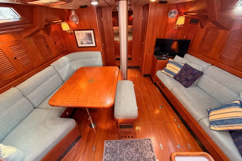 Slide: The Image of Luxurious 1991 Hylas 51 yacht interior with elegant wood finish and comfortable seating. - 49