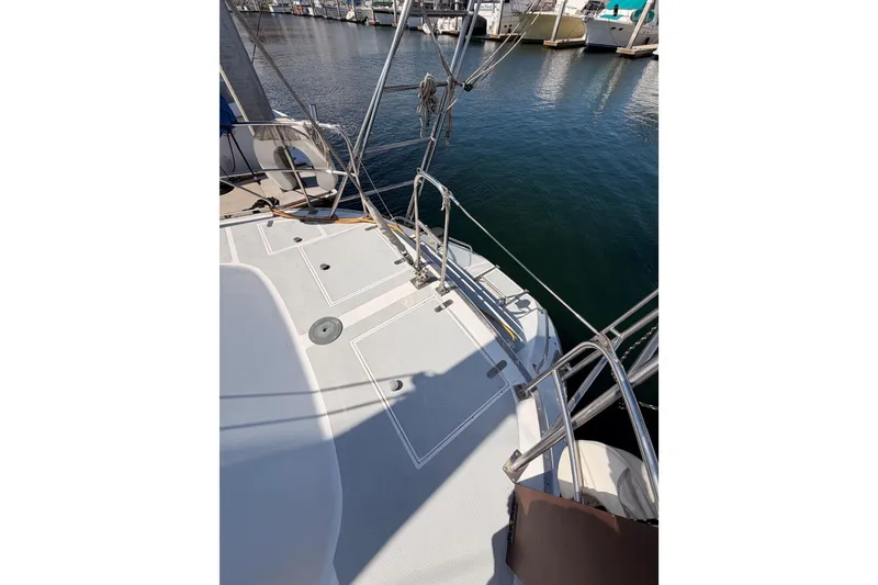 Slide: The Image of Deck view of a 1991 Hylas 51 sailboat docked at a marina. - 29