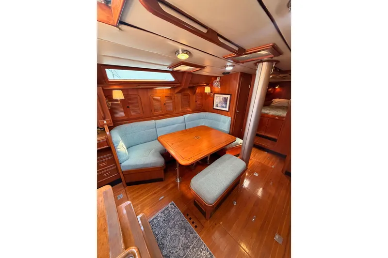 Slide: The Image of Luxurious interior of a 1991 Hylas 51 yacht with wooden finishes and cozy seating. - 52