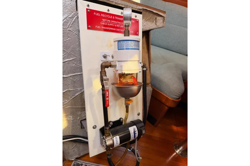 Slide: The Image of Fuel recycling system in a 1991 Hylas 51 yacht, featuring a filter and pump setup. - 114