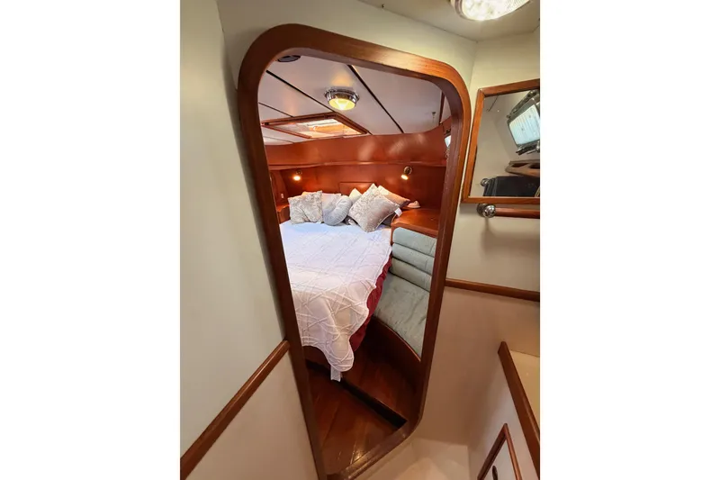 Slide: The Image of Cozy cabin interior of 1991 Hylas 51 yacht with wooden accents and plush bedding. - 70