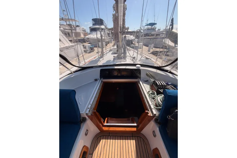 Slide: The Image of Cockpit view of a 1991 Hylas 51 sailboat, showcasing deck and marina surroundings. - 48