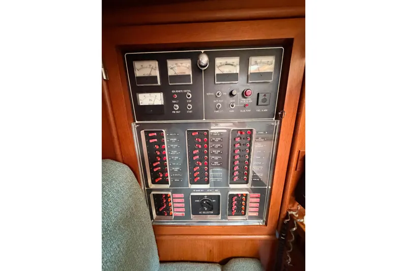 Slide: The Image of Electrical control panel on a 1991 Hylas 51 yacht, featuring gauges and switches. - 60