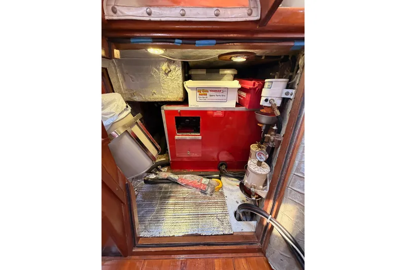 Slide: The Image of Engine compartment of a 1991 Hylas 51 yacht with spare parts and tools. - 56