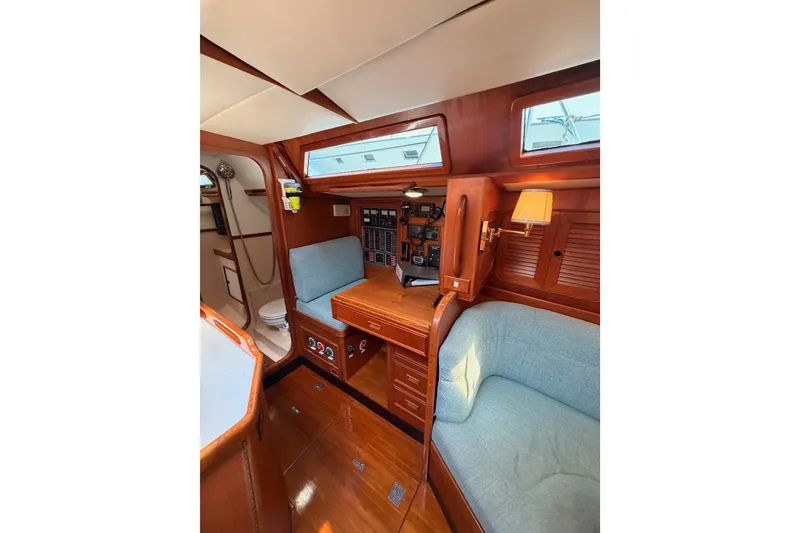 Slide: The Image of Interior of a 1991 Hylas 51 yacht with wooden furnishings and cozy seating. - 57