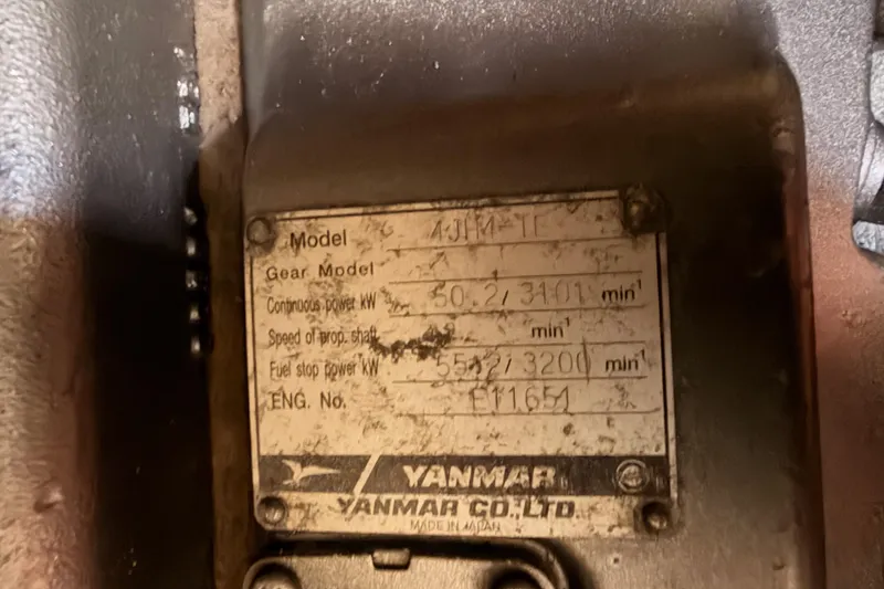 Slide: The Image of Yanmar engine plate on a 1991 Hylas 51, displaying model and power specifications. - 90