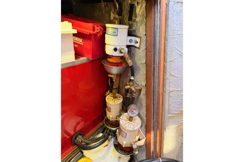 Slide: The Image of Engine compartment of a 1991 Hylas 51 yacht, featuring fuel filters and generator kit. - 115