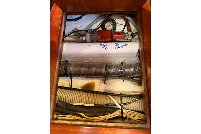 Slide: The Image of Interior view of a 1991 Hylas 51 yacht showing wiring and plumbing components. - 92