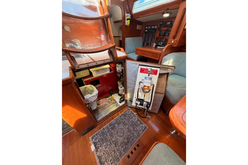 Slide: The Image of Interior of a 1991 Hylas 51 yacht showing engine compartment and control panels. - 55