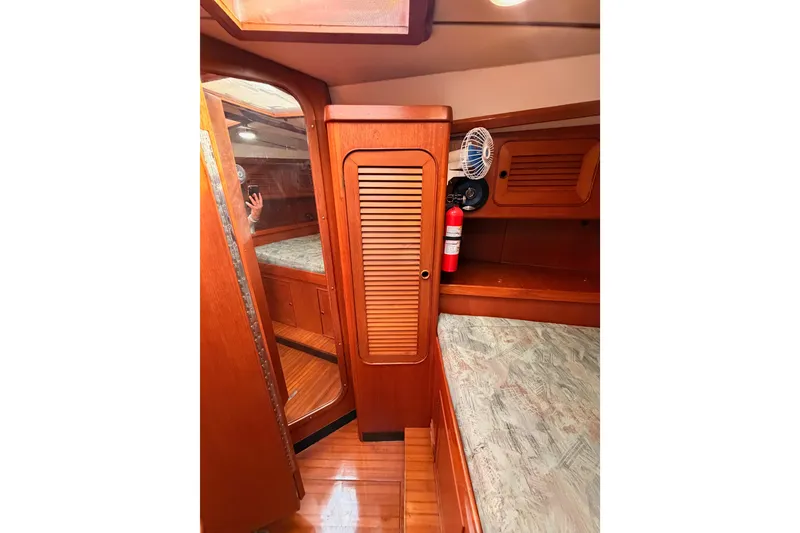 Slide: The Image of Interior of 1991 Hylas 51 yacht with wooden cabinetry and cozy sleeping area. - 105