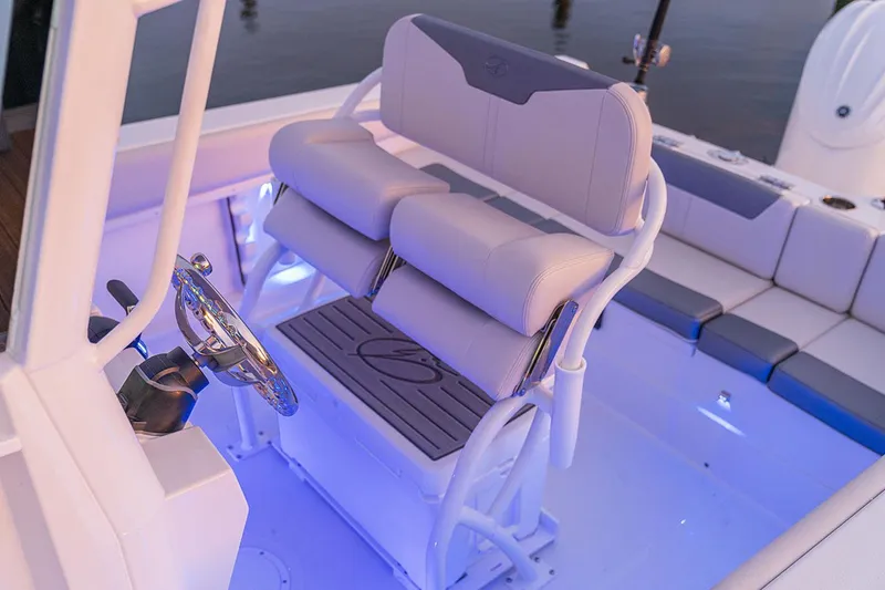 Slide: The Image of Manufacturer Provided Image: 2026 Sailfish 232 CC boat interior with illuminated seating and steering wheel. - 7