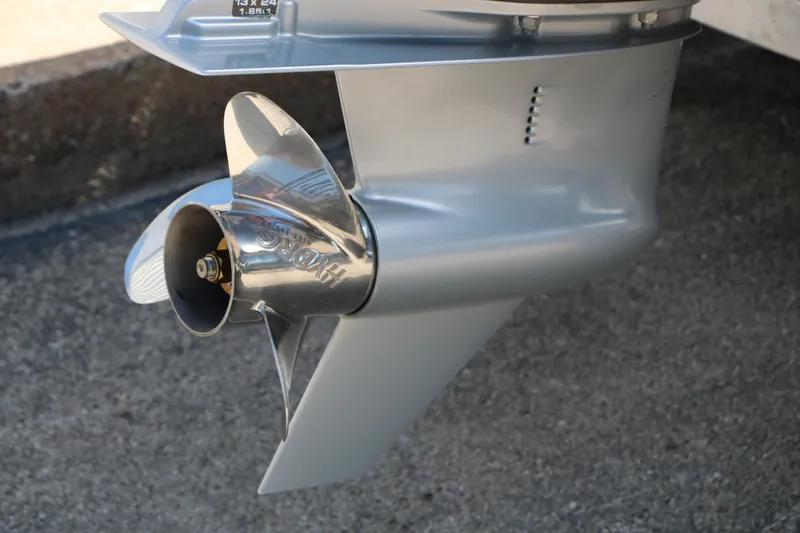 Slide: The Image of Close-up of a 2023 Alumacraft Competitor FSX 185 boat propeller on concrete surface. - 7