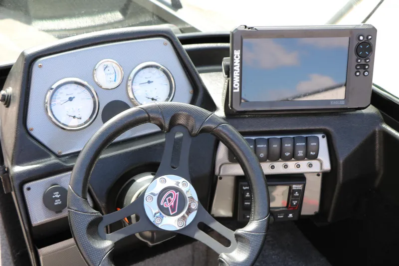 Slide: The Image of 2023 Alumacraft Competitor FSX 185 dashboard with steering wheel and Lowrance fishfinder. - 34